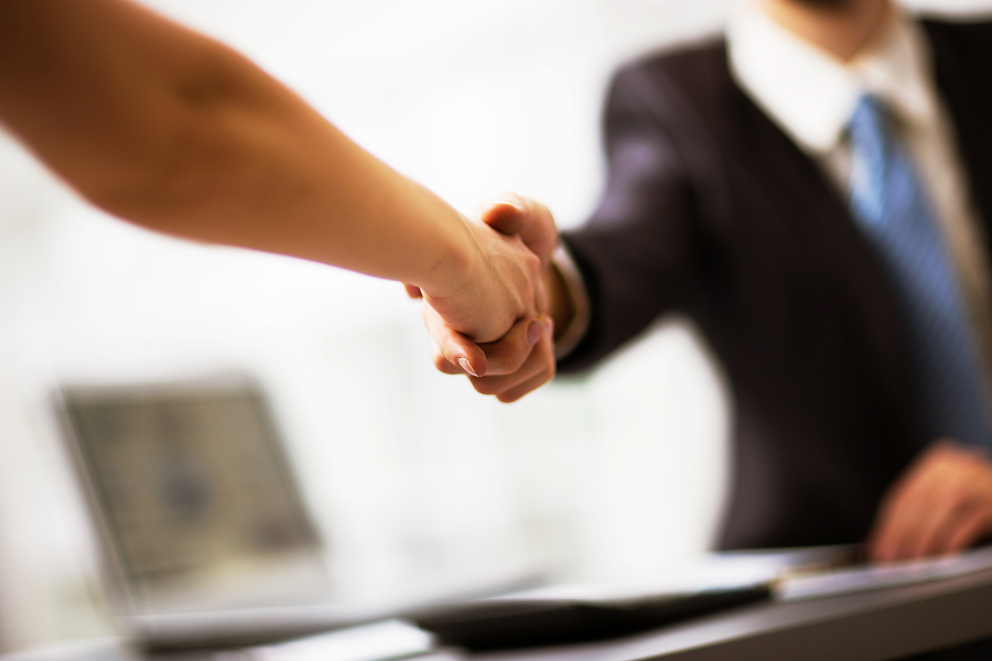handshake Two businesspeople shake hands.