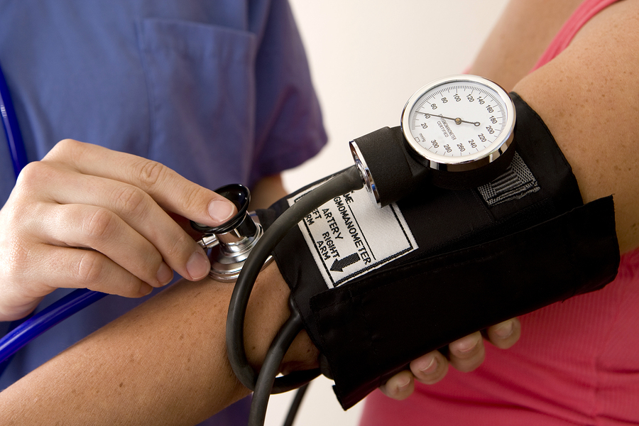 Multiple-state health plans A nurse takes a person's blood pressure with a pressure sleeve.
