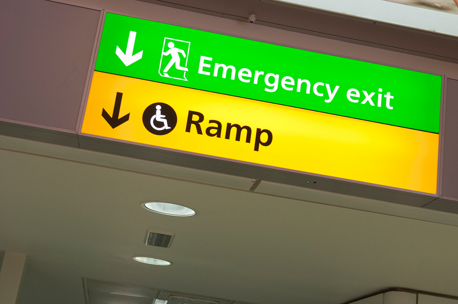 Emergency Exit Sign An emergency exit sign and an indicator for a wheelchair-accessible ramp.