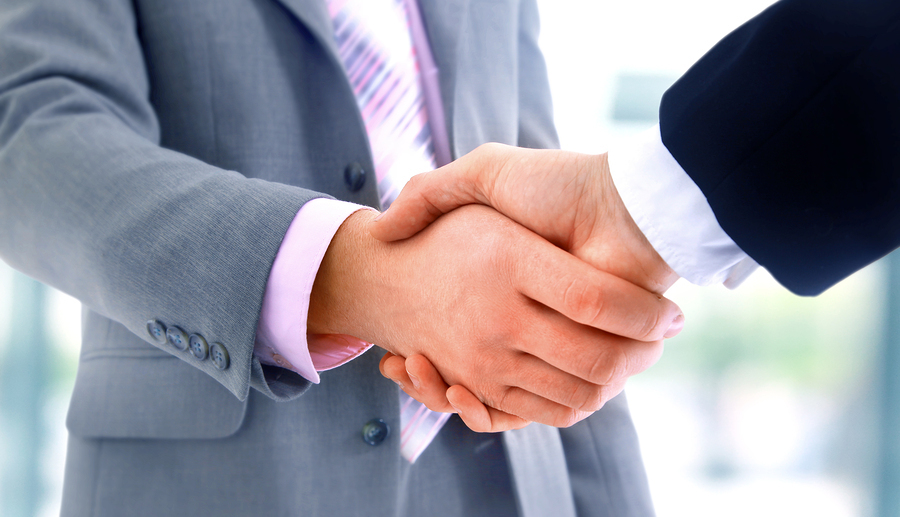 Handshake Two businesspeople in suits shake hands.